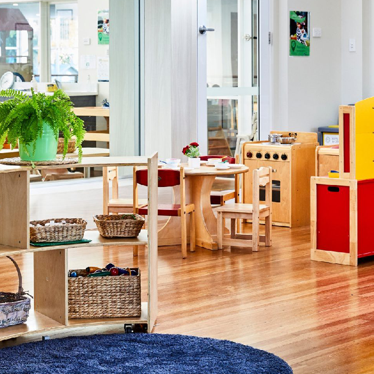 pre-K classroom with small bookshelf and table. 